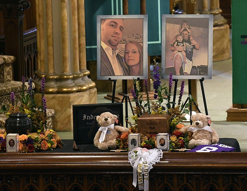 A unity urn with cremated ashes of Adam Jackson and Abigail Jackson is set in place as friends and family prepare for a funeral mass at St. Stanislaus Roman Catholic Church in Amsterdam, N.Y., for eight of the 20 people killed in last Saturday's fatal limousine crash in Schoharie, N.Y., Saturday, Oct. 13, 2018. (AP Photo/Hans Pennink)