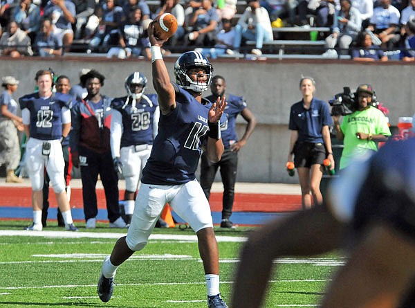 Lincoln quarterback Henry Ogala throws a pass during last Saturday afternoon's game against Quincy at Dwight T. Reed Stadium.