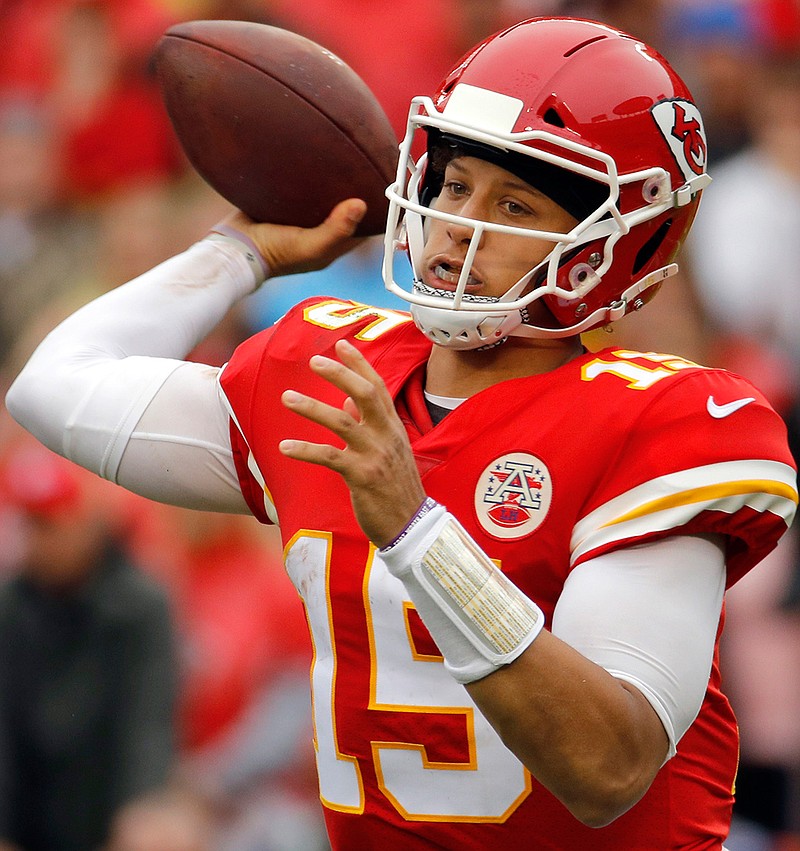 In this Oct. 7, 2018, file photo, Kansas City Chiefs quarterback Patrick Mahomes (15) throws a pass during the first half of an NFL football game against the Jacksonville Jaguars, in Kansas City, Mo. New England Patriots' Tom Brady, who will retire as possibly the best to ever play the position, faces Kansas City's Patrick Mahomes, the most electrifying quarterback in the NFL this season, on Sunday.  (AP Photo/Charlie Riedel, File)