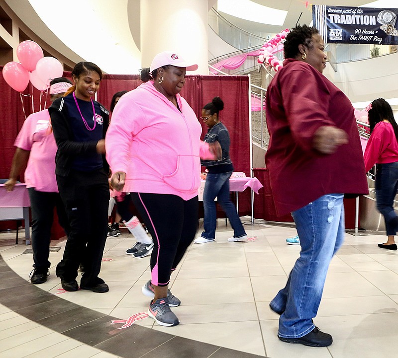 Community members participate in a cake walk Friday at Texas A&M University-Texarkana. The university held its second Pink Fest to help raise awareness of breast cancer and promote wellness during Pink Out Day across Texarkana.