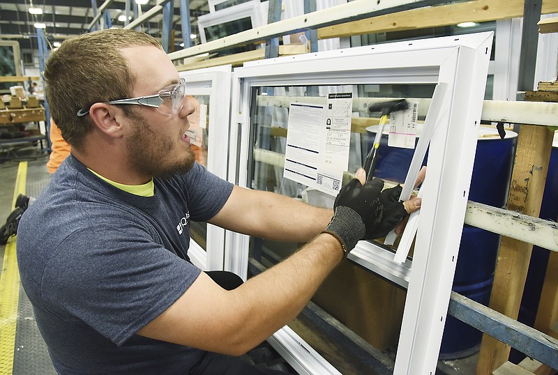 Julie Smith/News Tribune
Scott Large taps in gazing strips at the final assembly point at Quaker Window in Freeburg. Large has worked at the manufacturing facility for three years and said he enjoys his work. 