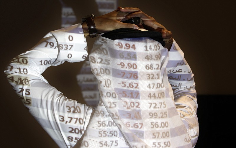 FILE - In this Oct. 7, 2008, file photo, a Saudi trader reacts as looks at the stock market monitor in Riyadh, Saudi Arabia. The Saudi stock market sharply fell Sunday after President Donald Trump threatened "severe punishment" over the disappearance of Washington Post contributor Jamal Khashoggi. (AP Photo/Hassan Ammar/File)