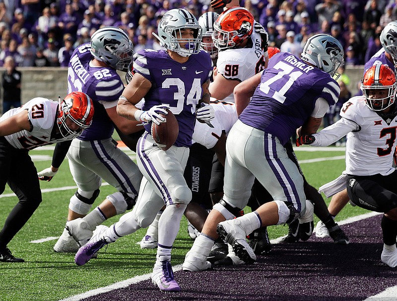 Kansas State running back Alex Barnes (34) scores a touchdown during the second half of an NCAA college football game against Oklahoma State in Manhattan, Kan., Saturday, Oct. 13, 2018. (AP Photo/Orlin Wagner)