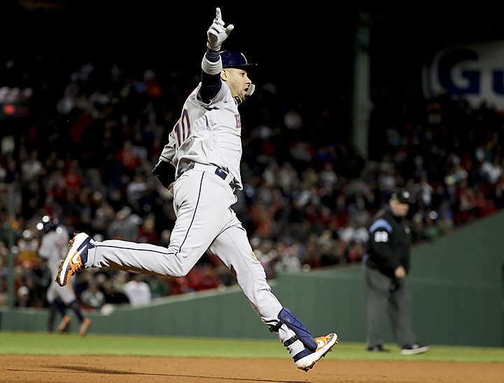 Houston Astros' Yuli Gurriel celebrates after his three-run home run against the Boston Red Sox during the ninth inning in Game 1 of a baseball American League Championship Series on Saturday, Oct. 13, 2018, in Boston. (AP Photo/David J. Phillip)