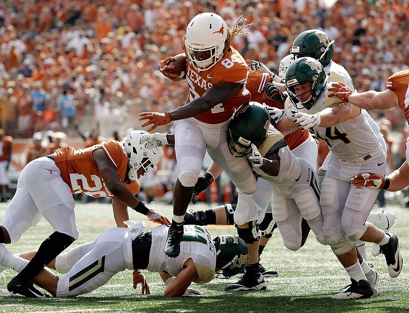 Texas wide receiver Lil'Jordan Humphrey (84) runs for a 3-yard touchdown against Baylor during the first half of an NCAA college football game, Saturday, Oct. 13, 2018, in Austin, Texas. (AP Photo/Eric Gay)