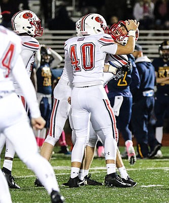 Ben Folz celebrates with teammate Jake Duke after making a game-winning 35-yard field goal Friday night against Battle in Columbia.