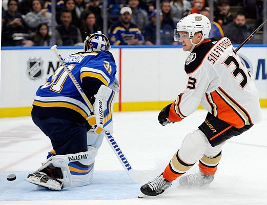 Jakob Silfverberg of the Ducks scores against Blues goalie Chad Johnson during the first period of Sunday night's game in St. Louis.