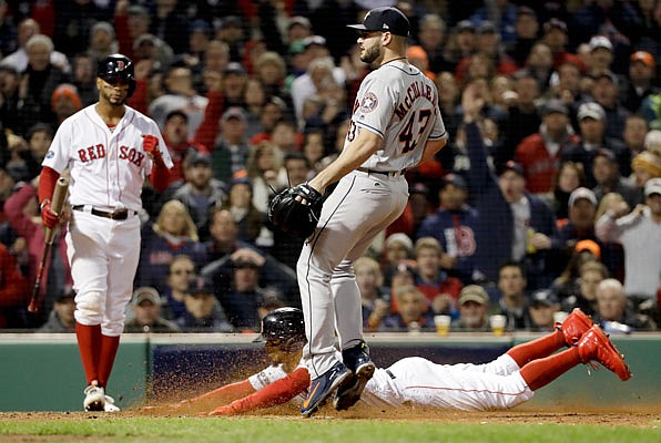 Mookie Betts of the Red Sox scores in front of Astros starting pitcher Lance McCullers Jr. on a passed ball during the seventh inning of Sunday night's Game 2 of the American League Championship Series in Boston.