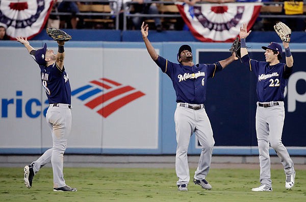 Brewers outfielders (from left) Ryan Braun, Lorenzo Cain and Christian Yelich celebrate Monday night after a 4-0 win in Game 3 of the National League Championship Series against the Dodgers in Los Angeles.