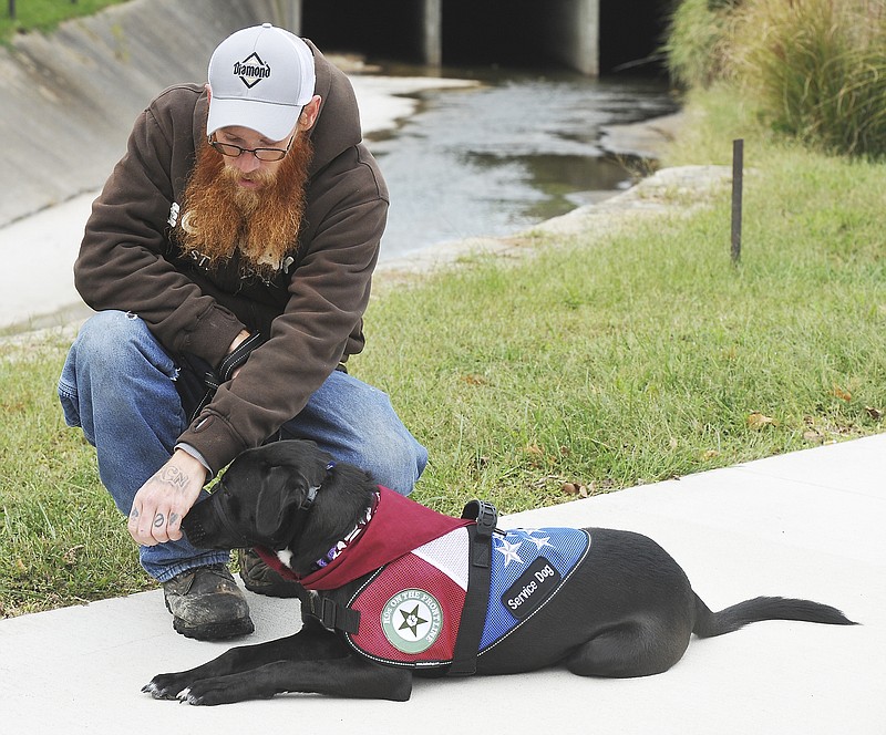 Julie Smith/News Tribune
Obey the command and get a treat, as shown here by Daniel Tooley who rewards Millie with a treat after she stopped and stayed while walking in downtown Jefferson City Monday. Tooley and Millie are participants in the first group of K9s on the Front Line training in Jefferson City.