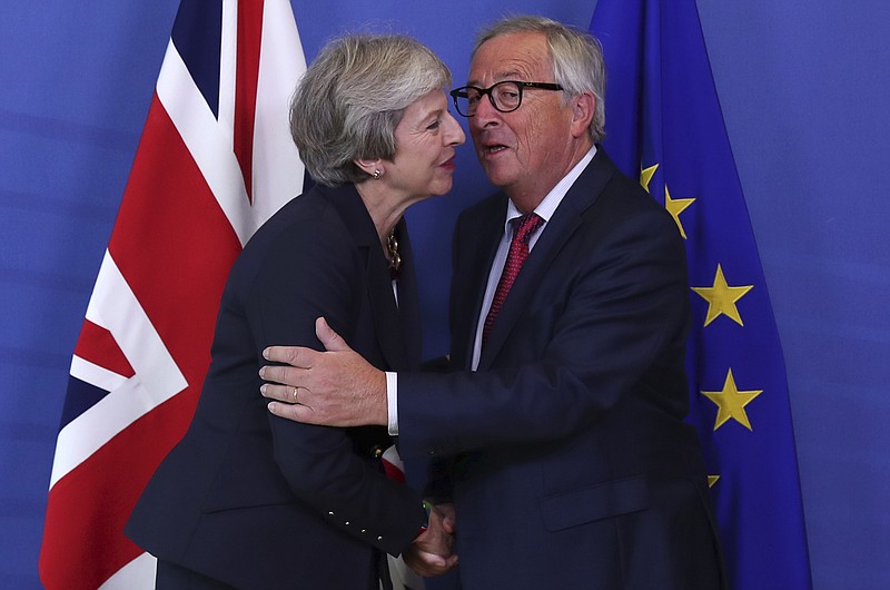 British Prime Minister Theresa May, left, hugs Jean-Claude Juncker, President of the European Commission, as they meet in Brussels, Wednesday, Oct. 17, 2018 when European leaders meet to negotiate on terms of Britain's divorce from the European Union. (AP Photo/Francisco Seco)