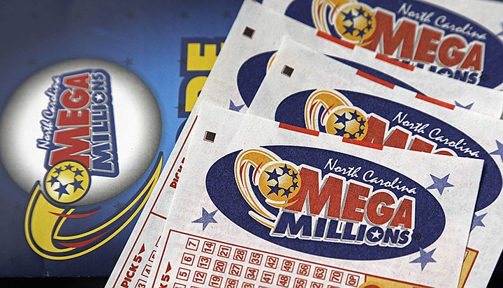  This July 1, 2016, file photo shows Mega Millions lottery tickets on a counter at a Pilot travel center near Burlington, N.C. After nearly three months without a winner, the Mega Millions lottery game has climbed to an estimated $654 million jackpot. Unfortunately, even as the big prize for its drawing Tuesday night, Oct. 16, 2018, increases to the fourth-largest in U.S. history , the odds of matching all six numbers and winning the game don't improve. They're stuck at a miserable one in 302.5 million. (AP Photo/Gerry Broome, File)