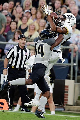 Missouri wide receiver Emanuel Hall reaches for a pass against the defense of Purdue cornerback Antonio Blackmon during last month's game in West Lafayette, Ind.