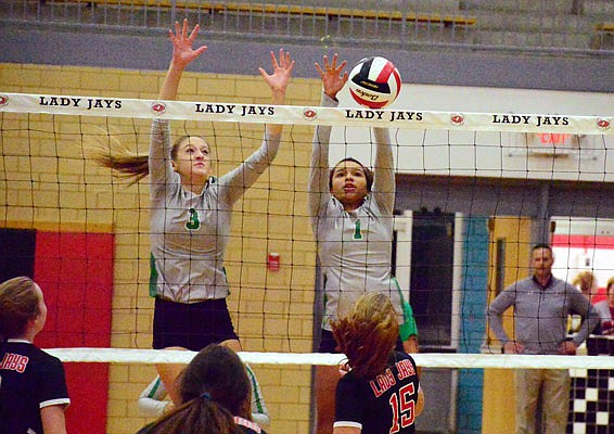 Blair Oaks teammates Emma Schroeder (left) and Mariah Radmacher go up for a block during Tuesday night's match against the Jefferson City Lady Jays at Fleming Fieldhouse.