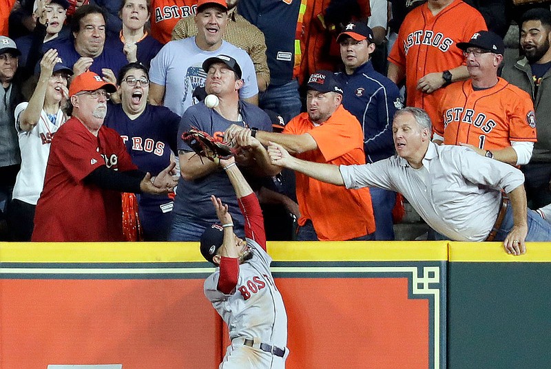 Fans interfere with Red Sox right fielder Mookie Betts trying to catch a ball hit by Jose Altuve of the Astros during the first inning of Wednesday's Game 4 of the American League Championship Series  in Houston. Altuve was called out. 