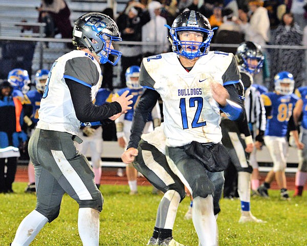 South Callaway junior running back Devin Borghardt (right) goes in motion while senior quarterback Peyton Leeper waits to take a snap during the Bulldogs' 41-21 Eastern Missouri Conference victory at Wright City last Friday. The Bulldogs host the North Callaway Thunderbirds in the annual Callaway Cup at 7 p.m. today.