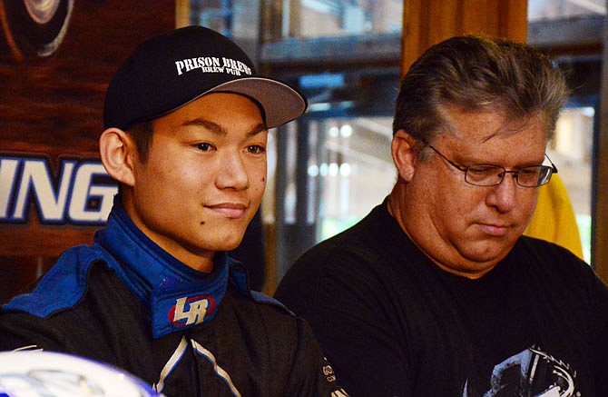 Jefferson City High School student Ryu Taggart speaks Wednesday at a press conference, flanked by his father, Jeff, at Prison Brews to announce his intent to compete for a spot in NASCAR's Drive for Diversity Program. Taggart was selected as one of 12 drivers from across the U.S.