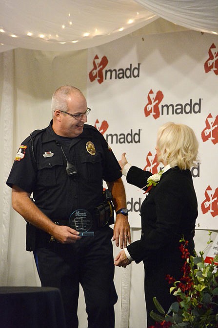 Jefferson City police officer Shawn Dumsday, left, receives an award Wednesday during the Heroes for Heroes event at the West Ridge Event Center in Centertown. Officers from Jefferson City and surrounding counties were nominated and recognized for their work keeping impaired drivers off the roads.