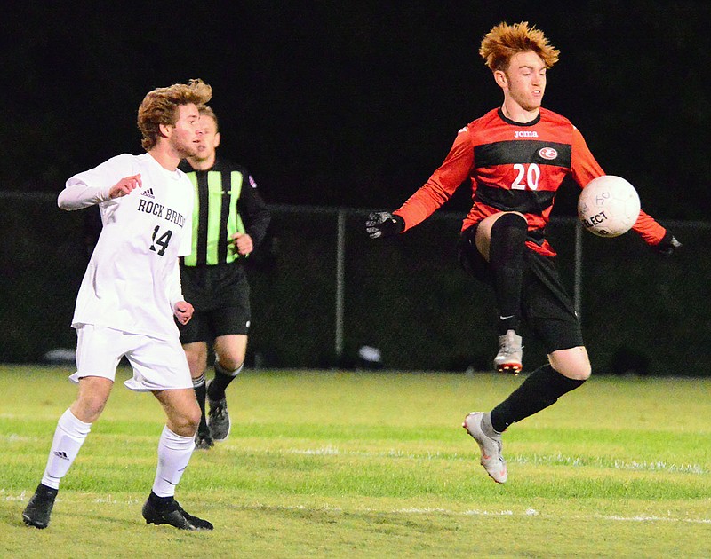 Breck McGrail of the Jays jumps to gain control of the ball as Preston Fancher of Rock Bridge looks on during Wednesday night's game at the 179 Soccer Park.