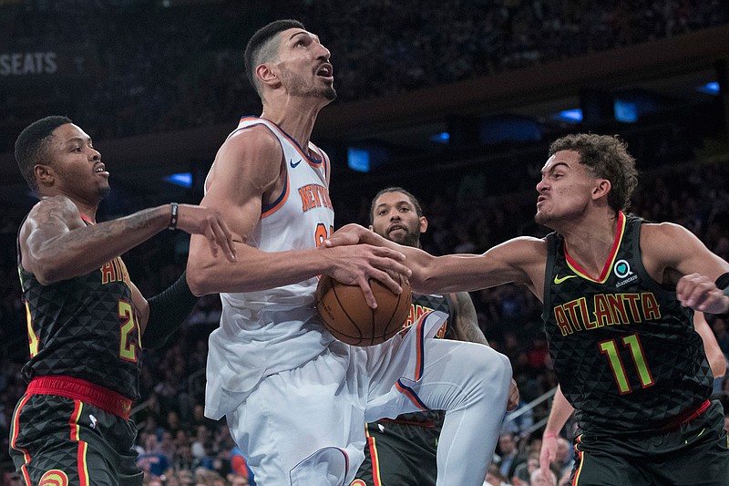 Atlanta Hawks guard Trae Young (11) fouls New York Knicks center Enes Kanter, center, during the second half of an NBA basketball game, Wednesday, Oct. 17, 2018, at Madison Square Garden in New York. The Knicks won 126- 107. (AP Photo/Mary Altaffer)