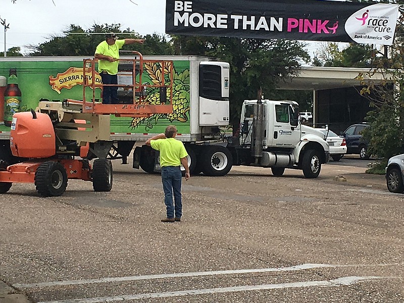  Workers prepare downtown Texarkana for the Susan G. Komen Race for the Cure.