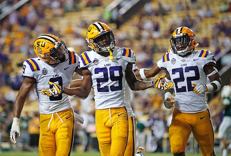 In this Sept. 8, 2018, file photo, LSU cornerback Greedy Williams (29) celebrates his interception with safety Grant Delpit (9) and cornerback Kristian Fulton (22) in the second half of an NCAA college football game against Southeastern Louisiana, in Baton Rouge, La. Williams was named to The Associated Press Midseason All-America team, Tuesday, Oct. 16, 2018. (AP Photo/Gerald Herbert, File)