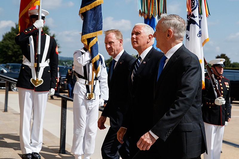 In this Aug. 9, 2018 file photo, Vice President Mike Pence, center, is greeted by Deputy Secretary of Defense Pat Shanahan, left, and Secretary of Defense Jim Mattis before speaking at an event on the creation of a United States Space Force at the Pentagon. With his demand that the Pentagon create a new military service -- a Space Force to assure "American dominance in space" -- President Donald Trump has injected urgency into a long-meandering debate over the best way to protect U.S. interests in space, both military and commercial. (AP Photo/Evan Vucci)