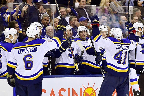 The Blues celebrate after an empty-net goal late in the third period of Saturday night's game against the Maple Leafs in Toronto.