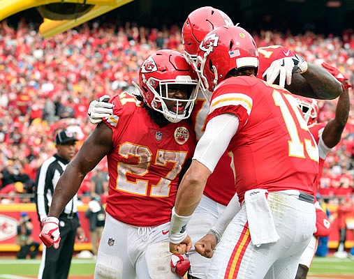 Chiefs running back Kareem Hunt (left) celebrates with teammates, including Patrick Mahomes (15), during a game against the Jaguars earlier this month in Arrowhead Stadium.