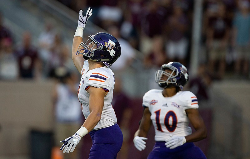  In this Aug. 30, 2018, file photo, Northwestern State's Ryan Reed (8) waves for a fair catch on the opening kickoff against Texas A&M during an NCAA college football game, in College Station, Texas. About 1 of every 10 kickoffs in the Football Bowl Subdivision have resulted in a fair catch giving the return team possession at its 25-yard line under a rule that went into effect this year. The purpose of the rule was to minimize kick returns, which have a higher injury rate compared with other types of plays. If a fair catch is made anywhere between the goal line and 25, it's a touchback and it's marked at the 25. (AP Photo/Sam Craft, File)