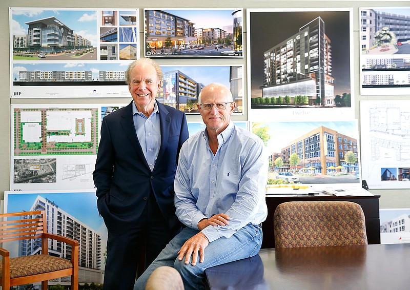 Former Dallas Cowboys players and now real estate partners Roger Staubach, left, and Robert Shaw pose at Columbus Reality Partners in Dallas, Thursday, Oct. 4, 2018. Roger Staubach wants more playing time with Robert Shaw. The Dallas Morning News reports in July, Staubach quietly retired as executive chairman of JLL Americas, and he's moving into new digs next to the third-floor offices of Shaw's company, Columbus Realty Partners Ltd., in Preston Center. Staubach says he'll continue to do selected projects for JLL, the Chicago-based real estate giant that bought Staubach Co. in 2008 for $640 million in a multiyear payout. But he'll be traveling less and spending more time going to his grandkids' events and doing deals with his buddy Shaw. (Tom Fox/The Dallas Morning News via AP)