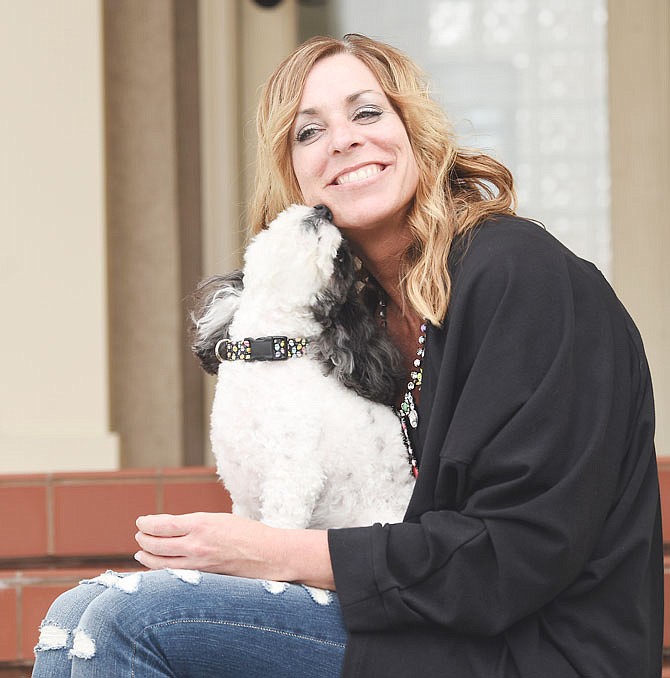 Olive brings a smile to the face of Lisa Bax as she does for children. Olive is trained to comfort children who are anxious or in distress as they go through court proceedings alongside a CASA volunteer. Olive was rescued from a California shelter and trained by "Lucky Dog" star Brandon McMillan to be a support dog. 