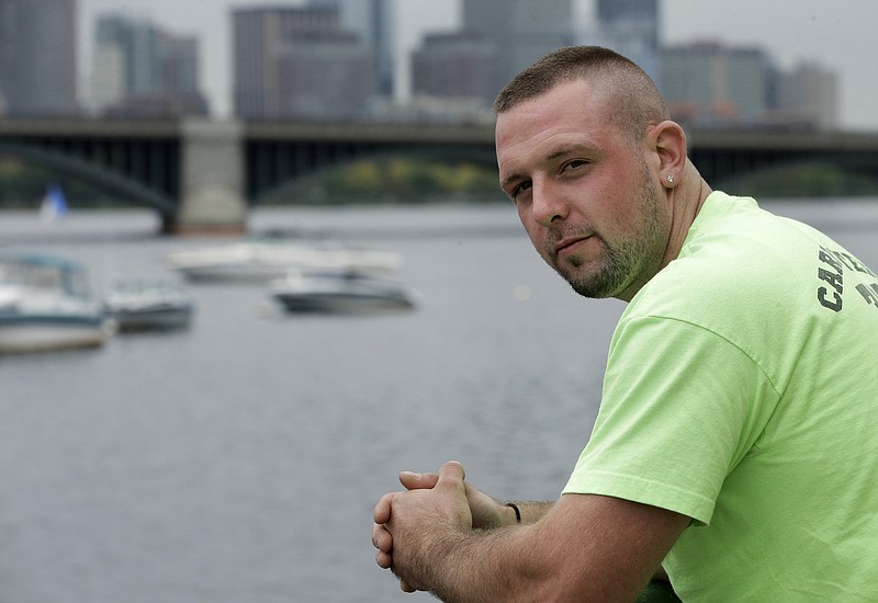 In this Monday, Oct. 1, 2018 photo Michael Robinson, of North Reading, Mass., in recovery from heroin addiction, stands for a photo near the Charles River, in Cambridge, Mass. Robinson recently became a union carpenter and has been working on building projects across the Boston area since. In Massachusetts, with Medicaid expansion already paying for opioid addiction treatment, emergency money from Congress goes largely toward recovery services. (AP Photo/Steven Senne)