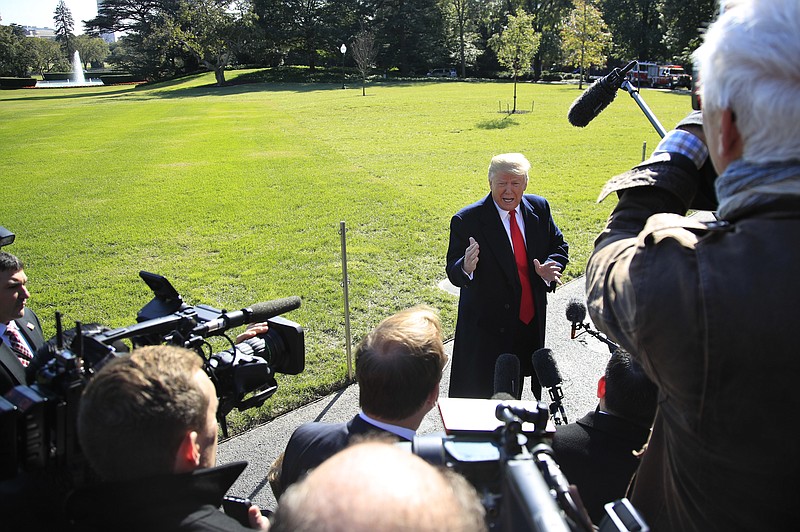 President Donald Trump speaks to reporters before leaving the White House in Washington, Monday, Oct. 22, 2018 to attend a campaign rally in Houston, Texas. (AP Photo/Manuel Balce Ceneta)