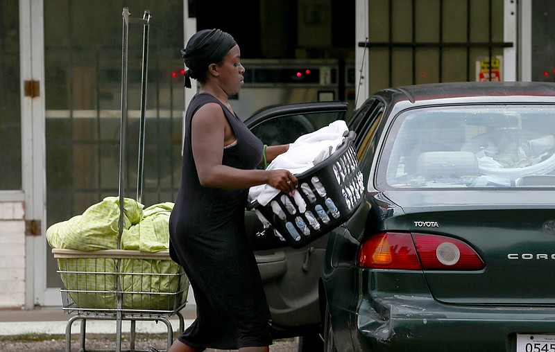 Ishmiya Morrison loads her clean laundry into her car Sept. 26, 2018, at a washateria in Houston. The laundromat was the site of a 2016 shooting that police solved with the help of a federal ballistics database.