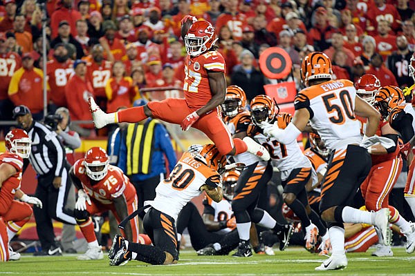 Chiefs running back Kareem Hunt vaults over Bengals safety Jessie Bates during the first half of Sunday night's game at Arrowhead Stadium.