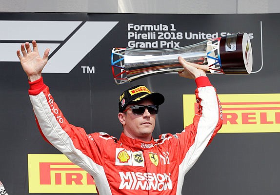 Kimi Raikkonen holds up the trophy Sunday after winning the Formula One U.S. Grand Prix at the Circuit of the Americas in Austin, Texas.