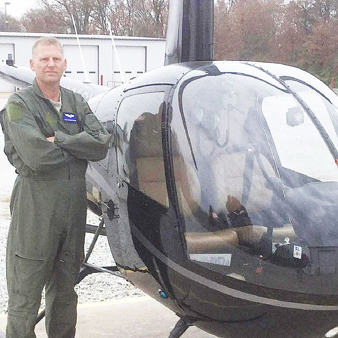 Charles Prather stands near a helicopter. The St. Louis-area man and former soldier died last week while flying near Fulton, leaving behind his parents. He will be buried Thursday in Jefferson Barracks National Cemetery.