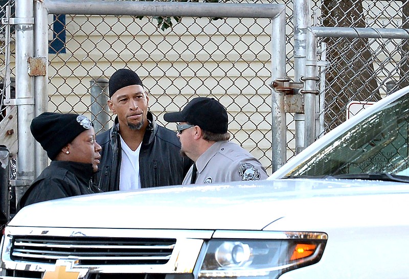 Former Carolina Panthers NFL football player Rae Carruth, center, exits the Sampson Correctional Institution Monday in Clinton, N.C. Carruth has been released from prison after serving 18 years for conspiring to murder the mother of his unborn child. 