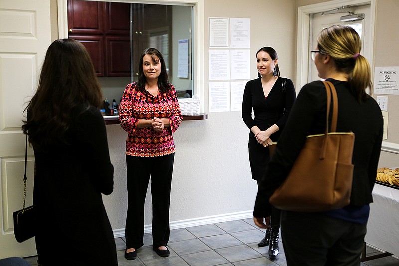 The managing attorney of Lone Star Legal Aid, Lisa Crittenden, speaks to representatives of Domestic Violence Prevention Inc. at the Lone Star Legal Aid's open house on Thursday in Texarkana, Texas. Lone Star Legal Aid is on 3001 Richmond Road.