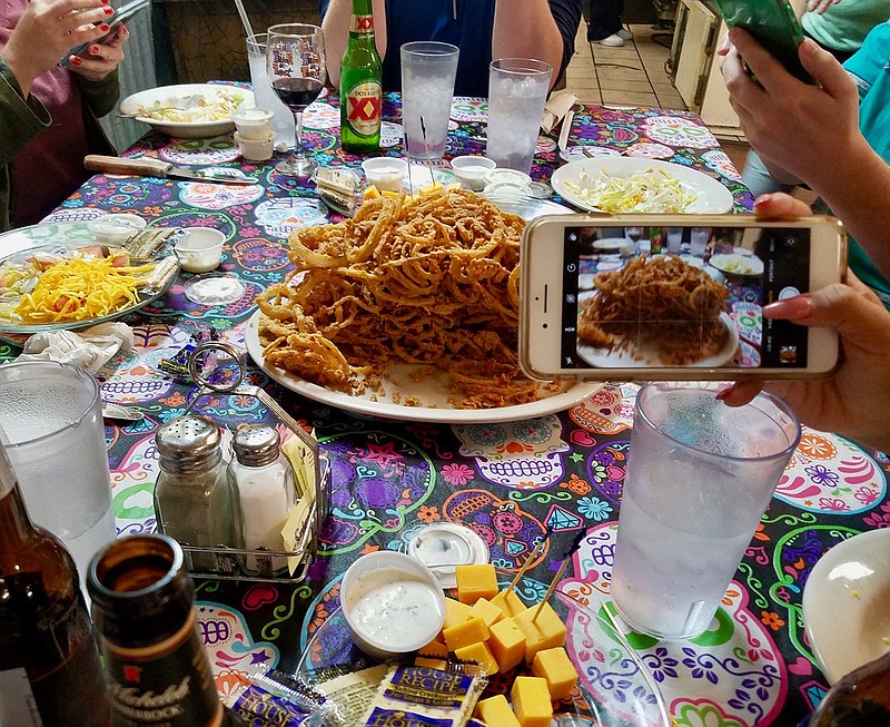  Travel writers take snapshots of a Longwood General Store favorite, the onion loaf, in Mooringsport, La. Longwood serves classic Southern fare. 