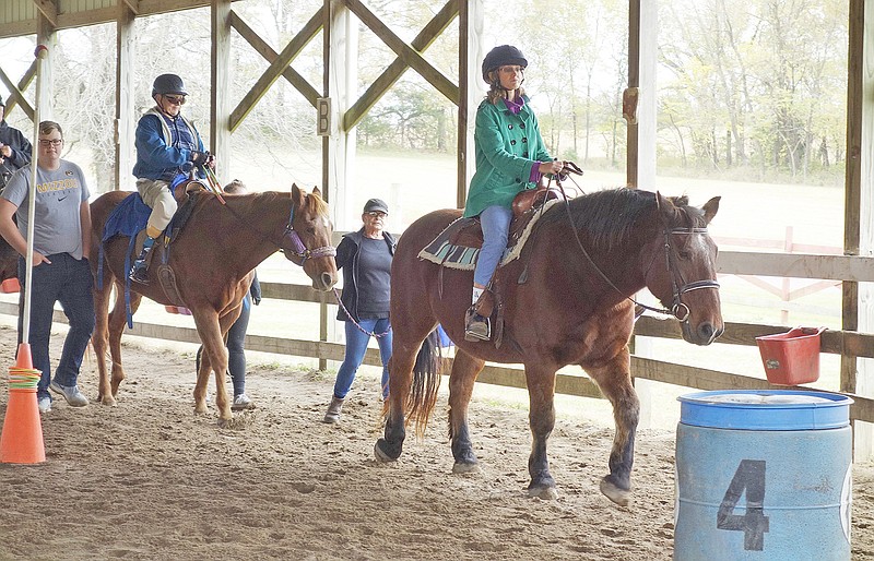 Riding at Cedar Creek Therapeutic Riding Center last week were Paige Speers of Fulton, followed by Barre Robinson of Fayette, a 1964 Westminster College graduate.