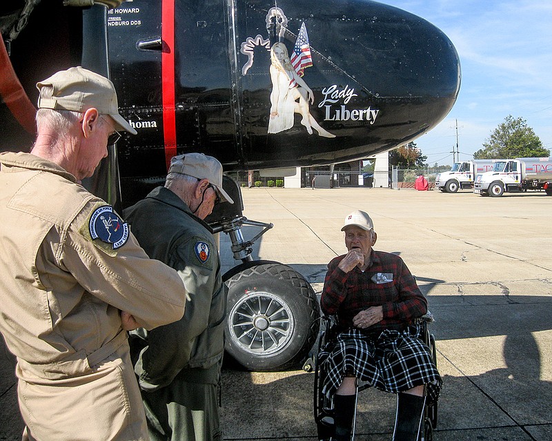 Former U.S. Army Air Force Capt. Ralph Miller, right, talks to Commemorative Air Force Flight Museum crew members about the museum's World War II A-26 Invader warplane, which flew strafing combat missions over Europe during the war. Miller, himself a WWII veteran, got the chance to fly an A-26 in the spring of 1944 while stationed in Lake Charles, La.