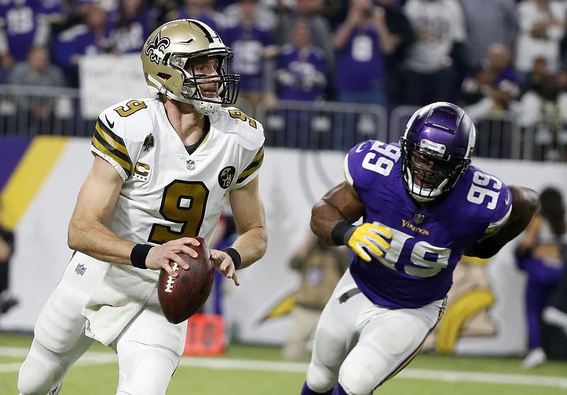 New Orleans Saints quarterback Drew Brees runs from Minnesota Vikings defensive end Danielle Hunter, right, during the second half of an NFL football game, Sunday, Oct. 28, 2018, in Minneapolis. (AP Photo/Bruce Kluckhohn)