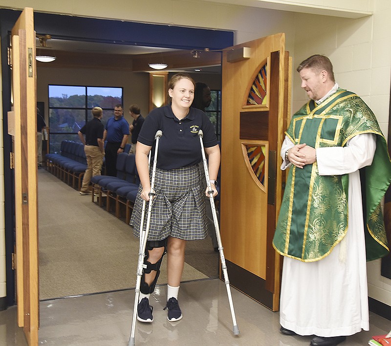 Fr. Stephen Jones greets freshman Eliza Pierce, as students, faculty, staff and visitors exit the chapel at Helias Catholic High School Wednesday. The school held its regular mass in the chapel before school Wednesday during which they offered up prayers for Darnell Gray, the young boy whose body was found Tuesday after a five-day search for the four-year-old. Gray was reported missing Thursday, Oct. 25, 2018 by his caregiver, Quatavia Givens, who is the girlfriend of the young boy's father. 