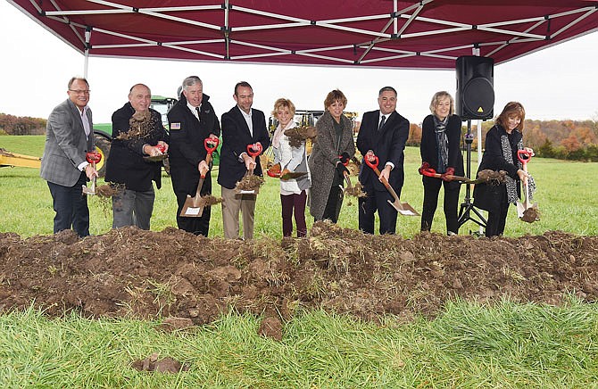 Michael Moehn, left, president of Ameren Missouri, joined elected officials and members of the Quaker Window Products family as the company hosted a groundbreaking ceremony Thursday in a field just west of Eldon. Others on hand for the ceremonial event are, from left, Moehn; Eldon Mayor Larry Henderson; Gov. Mike Parson; Quaker President and CEO Kevin Blansett; Judi Stone and Lotti Kaesik, both from board of directors; Rob Dixon, director of the Department of Economic Development; Mary Knoll and Pam Knoll. The Freeburg manufacturer will construct a 200,000-square-foot, $65 million facility on 127 acres on Hickey Road that will employ more than 300 people. 