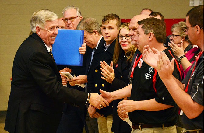 Gov Mike Parson shakes hands prior to speaking Thursday during a special dedication ceremony of the Special Olympics Missouri Training for Life campus. Special Olympics dignitaries were on hand as well as former Gov Jay Nixon and Mayor Carrie Tergin.