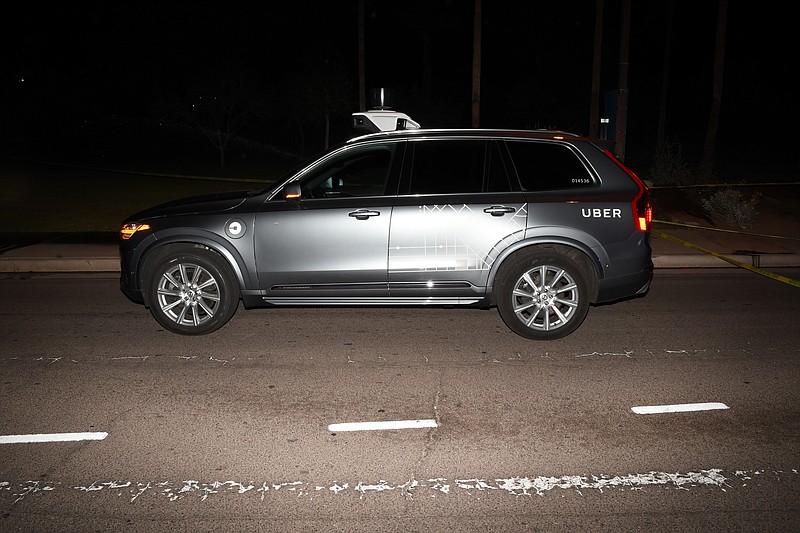 FILE - This file photo provided by the Tempe Police Department shows an Uber SUV after hitting a woman on March 18, 2018, in Tempe, Ariz.  Nearly eight months after one of its autonomous test vehicles hit and killed an Arizona pedestrian, Uber wants to resume testing on public roads. The company has filed an application with the Pennsylvania Department of Transportation to test in Pittsburgh, and it has issued a lengthy safety report pledging to put two human backup drivers in each vehicle and take a raft of other precautions to make the vehicles safe. Company officials acknowledge they have a long way to go to regain public trust after the March 18 crash in Tempe, Arizona, that killed Elaine Herzberg, as she crossed a darkened road outside the lines of a crosswalk. (Tempe Police Department via AP, File)