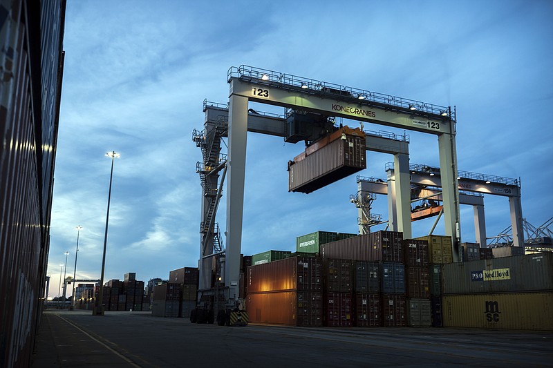 FILE- In this July 5, 2018, file photo, a rubber tire gantry moves a shipping container in the container yard at the Port of Savannah in Savannah, Ga. On Friday, Nov. 2, the Commerce Department reports on the U.S. trade gap for September. (AP Photo/Stephen B. Morton, File)