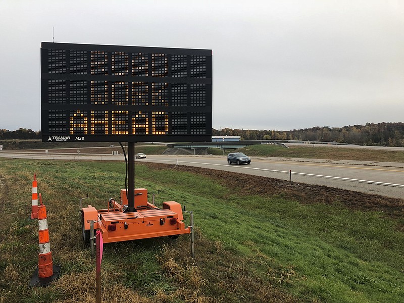 Vehicles pass by an electronic sign warning of upcoming road work along U.S. Highway 50 near Jefferson City, Missouri, on Nov. 1, 2018. (AP Photo/David A. Lieb)